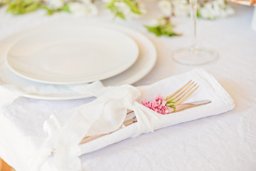 Plates and cutlery on bridal table, boho wedding table setting