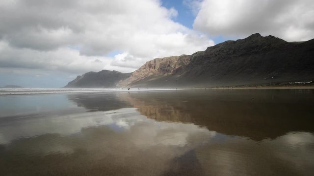 Rocks on the beach in Lanzarote. Reflecting beach on the Canary Islands. 