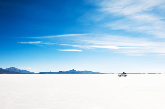 Off-road Car Driving On Salar De Uyuni Salt Flat In Bolivia. South America Landscapes.