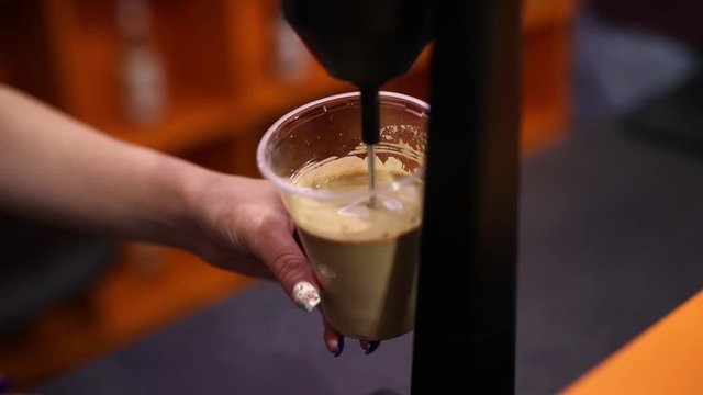 Bartender makes frappe coffee cocktail in night bar with mixer. 