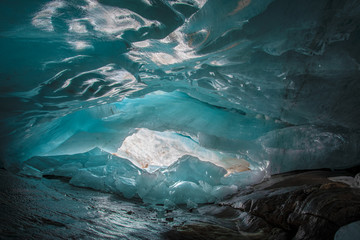 beautiful blue ice glacier cave grotto inside the mountain glacier Alibek, Dombay