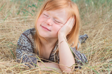 Portrait of a beautiful red-haired girl with freckles