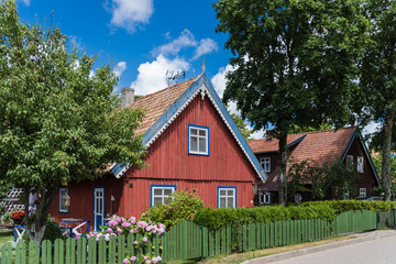 Traditional wooden house on Curonian Spit village Nida; Lithuania - obrazy, fototapety, plakaty