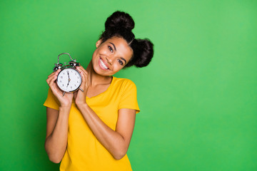 Photo of amazing dark skin lady holding big metal alarm clock recommending for using people who...