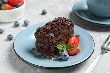 Fototapeta na wymiar Delicious fresh chocolate cake with berries on table