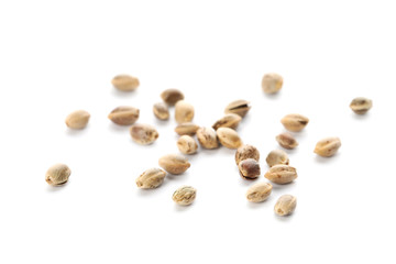 Raw organic hemp seeds on white background