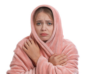 Young woman suffering from cold on white background
