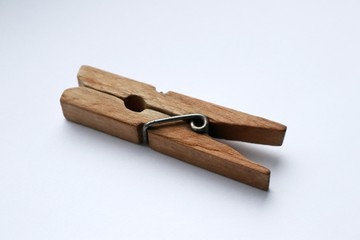 light brown wooden clothespin on a white background
