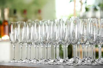 Empty glasses on wooden table against blurred background