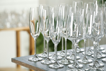 Empty glasses on wooden table against blurred background