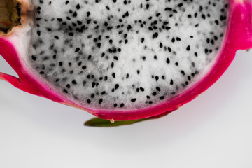 Dragon fruit. Vibrant Dragon Fruit on white background. Sliced white dragon fruit or pitaya on white plate on the table, close-up. Tropical and exotic fruits. Healthy and vitamin food concept.