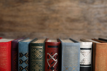 Stack of hardcover books on wooden background, closeup. Space for text