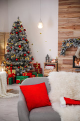 Obraz na płótnie Canvas Stylish room interior with beautiful Christmas tree and gift boxes