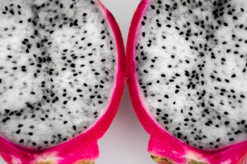 Dragon fruit. Vibrant Dragon Fruit on white background. Sliced white dragon fruit or pitaya on white plate on the table, close-up. Tropical and exotic fruits. Healthy and vitamin food concept.