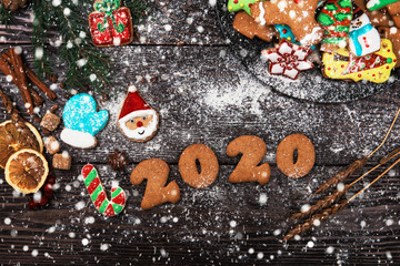 Different ginger cookies for new 2020year holiday on wooden background, xmas theme
