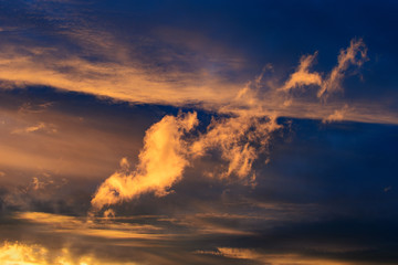 Dramatic sky at sunset or sunrise with red and orange clouds. Variegated colored clouds at the evening sunset of the summer sky.