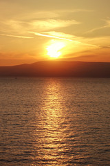 Photo of beautiful cloudy sunset with golden colours over the Aegean sea