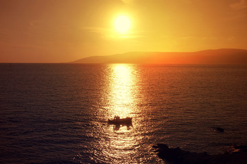 Fototapeta premium Photo of beautiful cloudy sunset with golden colours over the Aegean sea