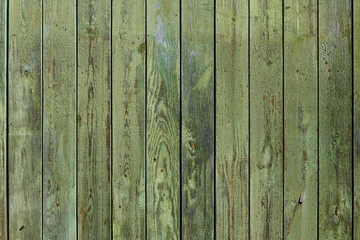 Wooden surface with cracked green paint texture