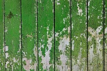 Wooden surface with cracked green paint texture