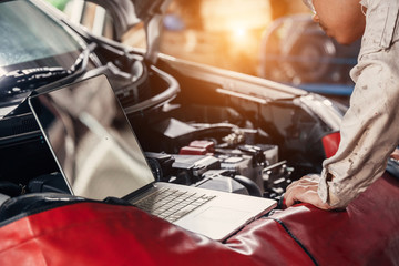 Professional car mechanic working in auto repair service.