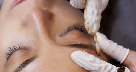 Beautician specialist of permanent makeup making brow microblading tattooing make up - obrazy, fototapety, plakaty
