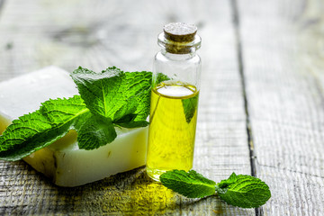 herbal extract in glass bottles and soap for spa on wooden table background