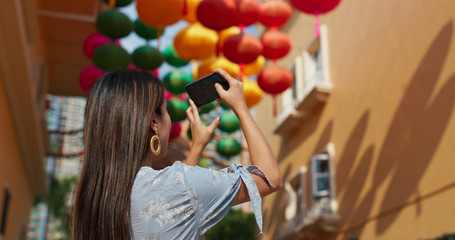 Woman take photo on mobile with chinese lantern at outdoor
