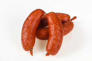 Tasty meat sausages over white background