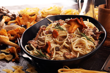 pasta with organic chanterelles. portion of spaghetti pasta with fried chanterelles in a creamy...