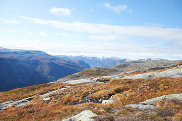 Travel around Norwegian national park at autumn season, hiking in mountains.