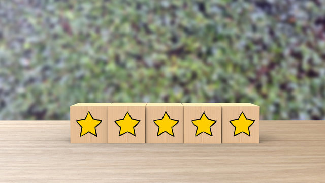 Five Star Cartoon Sketch Style On Wooden Cube Review Blur Leaves Background. Service Rating, Satisfaction Concept. Reviews And Comments Google Maps, Tripadvisor, Facebook. Online Evaluations.