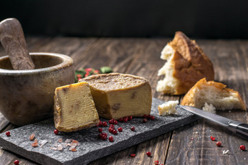 Artesian Cheese and a homemade souer dough bread on wooden background.