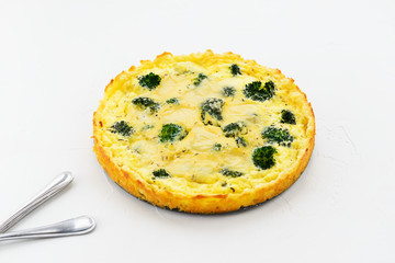 Homemade tart with broccoli and cheese on a white background.