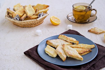 Homemade cottage cheese cookies in a clay plate on a light background concrete. Baking with cottage cheese.