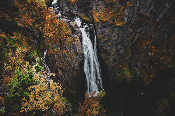 Beautiful mountain waterfall at scandinavian national park with scenic views of wild nature.