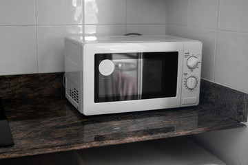 Microwave in a kitchen for cooking or heating a dish.
