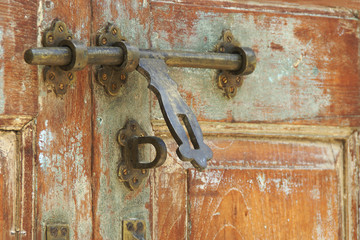 Vintage Style Rustic Brass Door Bolt on Old Wooden Door