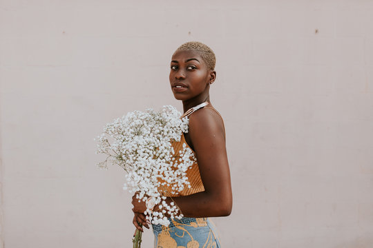 Portrait Of Woman With Bouquet Of Gypsophila Standing Outdoors