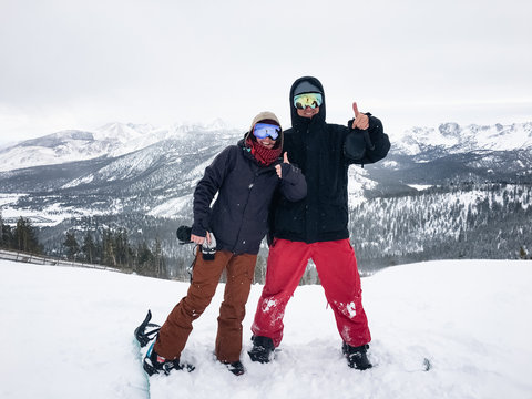 Happy Couple on Snowboards