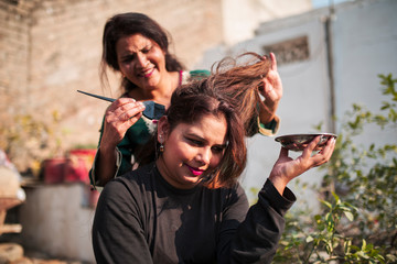 Applying henna hair dye