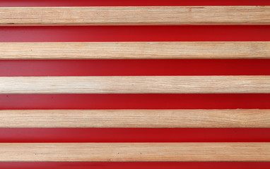 Wooden planks on a red background. Horizontally arranged boards on a red background