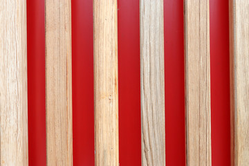 Wooden planks on a red background. Vertically arranged boards on a red background