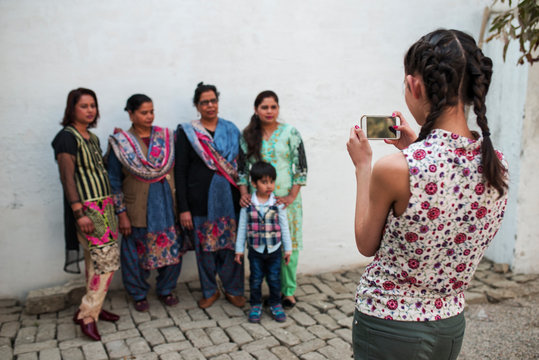 Girl takes family portrait with phone