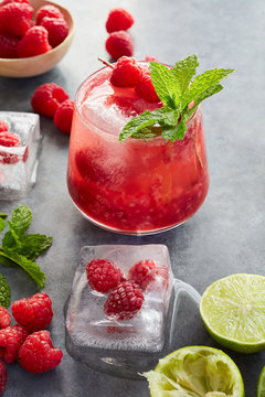 Muddled raspberry margarita on a concrete surface