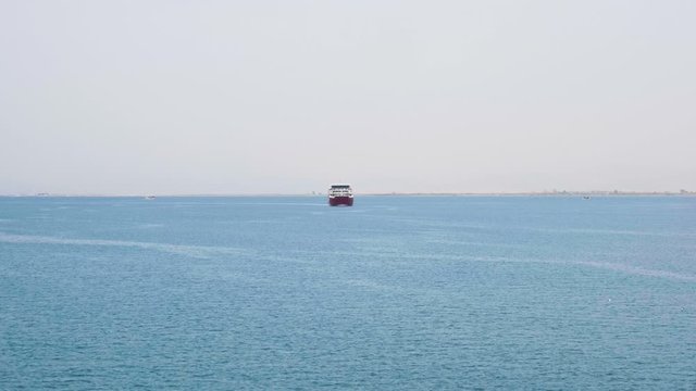 Big ferry boat sailing on open sea from coast to coast.