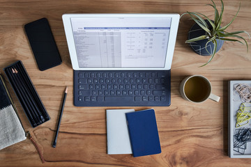 Overhead shot of a tablet computer on a wooden desk