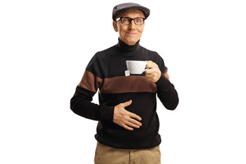 Elderly man holding a cup of tea and his hand on his abdomen
