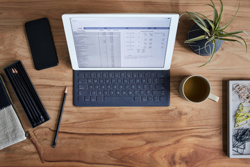 Overhead shot of a tablet computer on a wooden desk