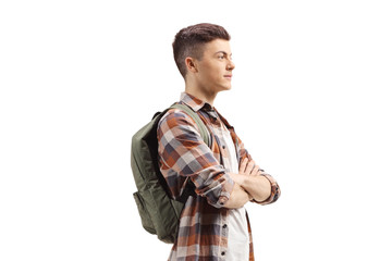 Young guy with a backpack standing with arms crossed